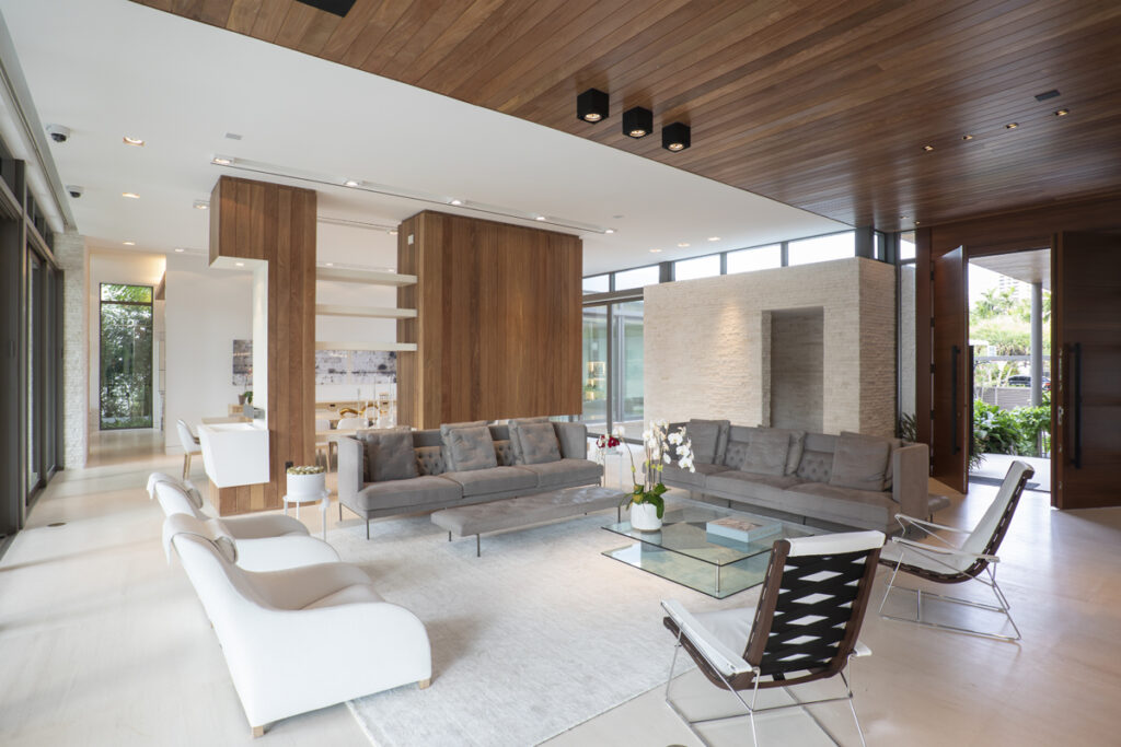 Modern Malibu living room with Cumaru wood ceiling and wall accents, neutral furniture, and open-concept design