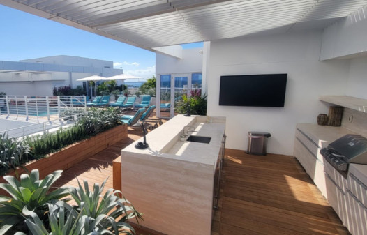 Ipe wood rooftop deck with outdoor kitchen and poolside lounge in Malibu, California
