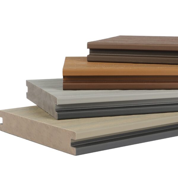 Close-up of Deckotech Terra Essence Collection composite decking boards in multiple colors, showing grooved edges and co-extruded grain finish